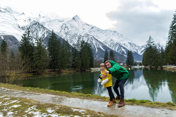 Father and son togethe having the holiday at Gaillands lake in Chamonix, french alps.Father point to the mounths.