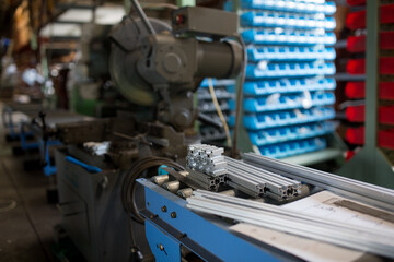 Work cutting an aluminum frame with a metal saw
