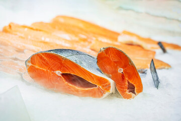 Fresh salmon steaks on ice for sale in supermarket. Healthy eating concept