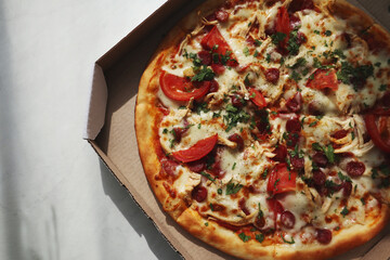 Tasty pizza in paper box on table