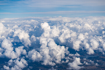 Cumulus clouds, sky view, and flying through the sky in a plane
