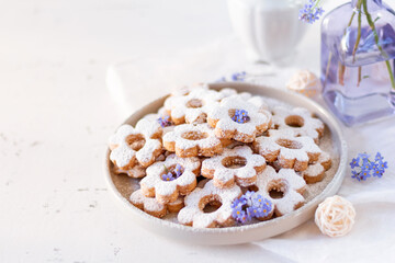 Fototapeta na wymiar Italian traditional cookies are canestrelli on a white background with flowers. Homemade pastries. The concept of breakfast. 