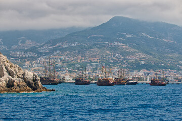 Fototapeta na wymiar Pirates boats in Antalya bay nearby the beach