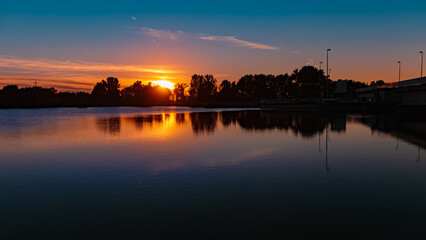 Fototapeta premium Beautiful sunset with reflections near Plattling, Isar, Bavaria, Germany