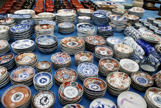Japanese porcelain dishes on sale at the famout Kobo Market in Kyoto. Imari ware produced in the town of Arita at the Kyushu Island, colorful, decorative ceramic plates and urushi lacquerware.