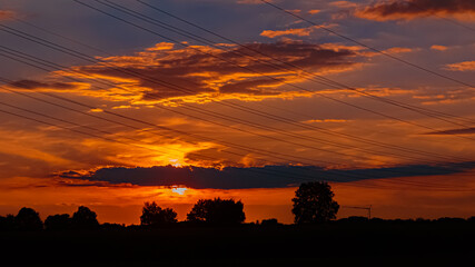 Beautiful sunset with a dramatic sky near Tabertshausen, Bavaria, Germany