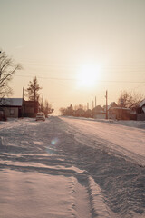 Snow-covered village streets and wooden
