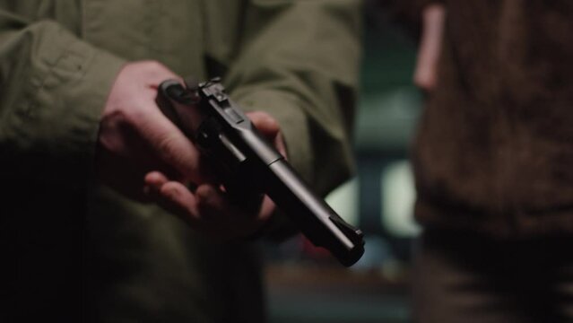 Hunter holding and loading Revolver before shooting it at an shooting range