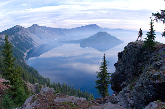 Young man hiking at Crater Lake National Park, Oregon.