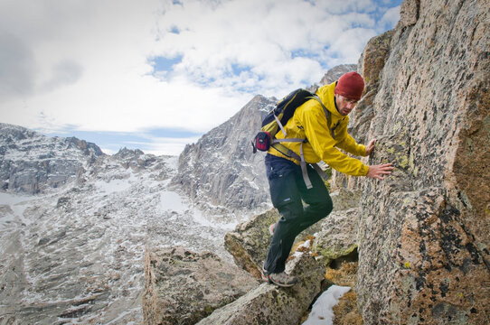 A man climbing Arrowhead Peak. (12387 ft.) Rocky Mountain National Park, CO.