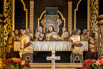 woodcarving depicting the Eucharist on the altarpiece in Elmelund church - obrazy, fototapety, plakaty