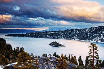 Clouds are illuminated at sunset over Emerald Bay in the winter, CA.