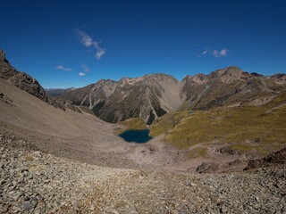 Southern Alps mountain panorama of scenic alpine tarn lake in Nelson Lakes National Park Tasman South Island New Zealand