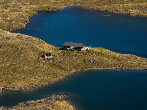 Scenic mountain panorama of idyllic alpine Angelus Hut on lake shore in Nelson Lakes National Park Tasman New Zealand