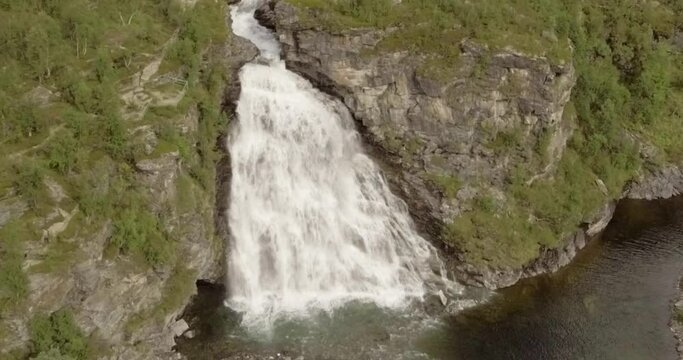 Aerial view of  Rovijokkfossen waterfall on the E8 Nordlysveien road in summer, Storfjord, Troms og Finnmark, Norway.