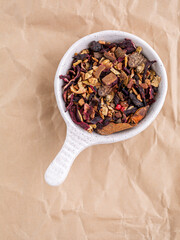 Mixture for mulled wine in a white bowl on Kraft paper. Macro shooting