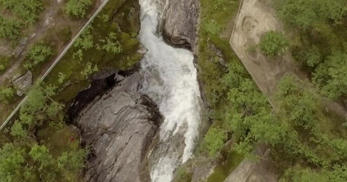 Aerial view of  Rovijokkfossen waterfall on the E8 Nordlysveien road in summer, Storfjord, Troms og Finnmark, Norway.