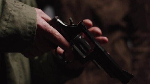 Hunter holding and loading Revolver before shooting it at an shooting range