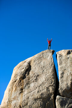 Male climber on top of rock