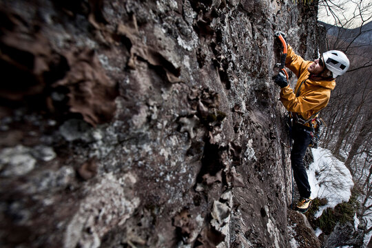 An ice climber weaves his way up "Porcelain Pillar" utilizing bits of frozen turf and cracks in the rock to aid his progression in the Stoney Clove area of the Catskill mountains, 