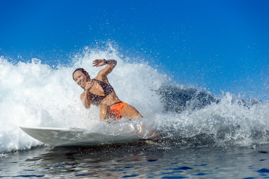 Woman surfing in sea, Banda Aceh, Sumatra, Indonesia