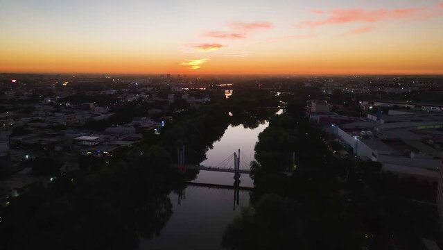 R&iacute;o Tamazula river, vibrant dusk in Culiacan city, Sinaloa, Mexico - Aerial view