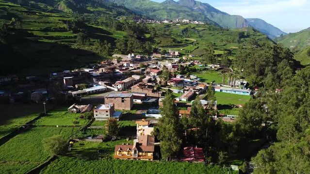 Orbit Shot Of Distant Town In Heart Of Nature In Obrajillo, Canta, Peru