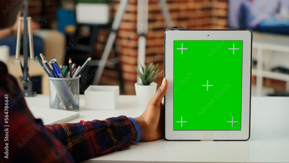 Poster office worker vertically holding digital device with greenscreen and isolated mockup template. worki