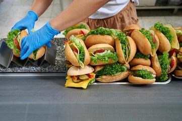 a pile of handmade sandwiches on a store shelf