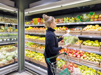 Woman buying fruits and vegetables at the market