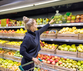 Woman buying fruits and vegetables at the market