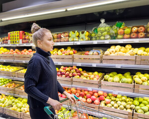Woman buying fruits and vegetables at the market