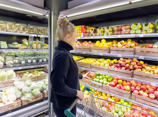 Woman buying fruits and vegetables at the market