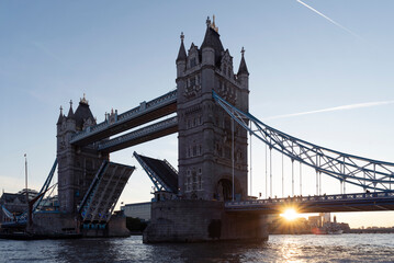Fototapeta na wymiar Tower Bridge in UK with the sun in the morning. Capital city in Great Britain with famous building and architecture with river. Tourism and attraction in Europe.