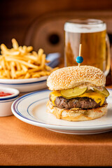 Hamburger. Bacon Cheeseburger. Classic traditional American bar, restaurant entree. Beef hamburger with Swiss and cheddar cheeses served with lettuce, tomato, onion and hand cut french fries. 
