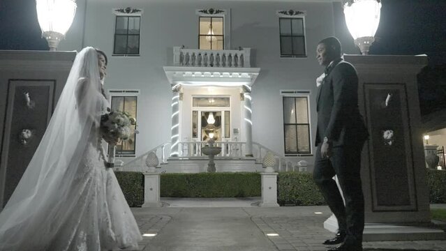 Bride and groom holding hands as they walk into mansion wedding venue. Outdoors winter wedding. Shot in 4K 60 FPS. To purchase entire event raw at wholesale price email willneatheryyahoo.com.