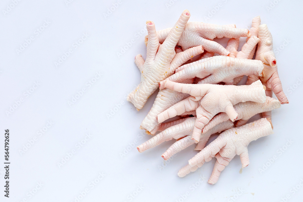 Wall mural Raw chicken feet on white background