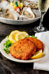 Crab cake. Crab cake served with spicy rémoulade sauce on top of a mixed green salad. Jumbo crab meat mixed with garlic, onions, spices and fried in butter. Classic American restaurant appetizer.