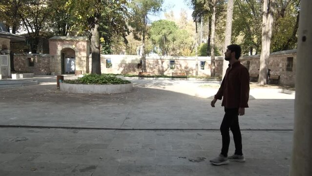 Man Walking In Mosque Garden