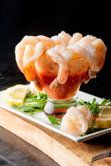 Shrimp cocktail. Seafood platter or shrimp cocktail. Jumbo shrimp, oysters, clams, crab claws served on ice garnished with lemon wedges. Classic American party appetizer.