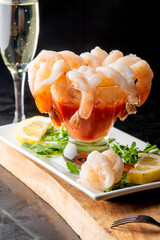 Shrimp cocktail. Seafood platter or shrimp cocktail. Jumbo shrimp, oysters, clams, crab claws served on ice garnished with lemon wedges. Classic American party appetizer.