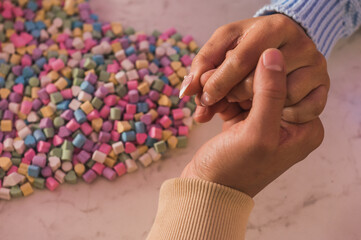 Wedding couple holding hands with a heart made of sweets.