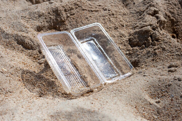 Plastic food container on the beach