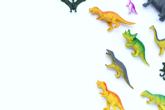 Plastic dinosaur toys on white background. Top view