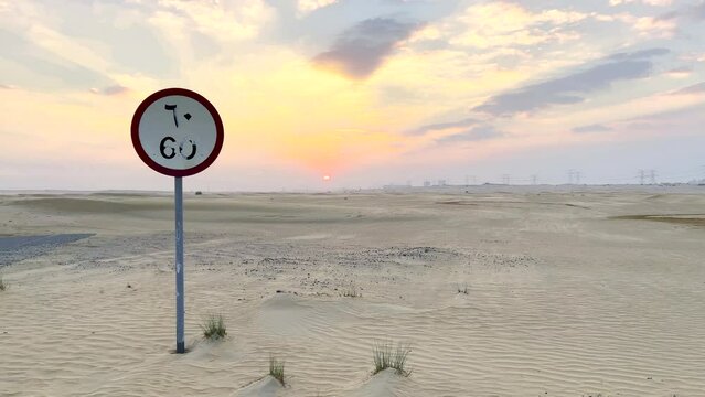 60 km speed limit road sign in the middle of the Arabian desert at sunset