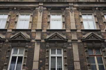 Old building with decorative architectural elements: pilasters, bas-reliefs, brackets, pediments…...