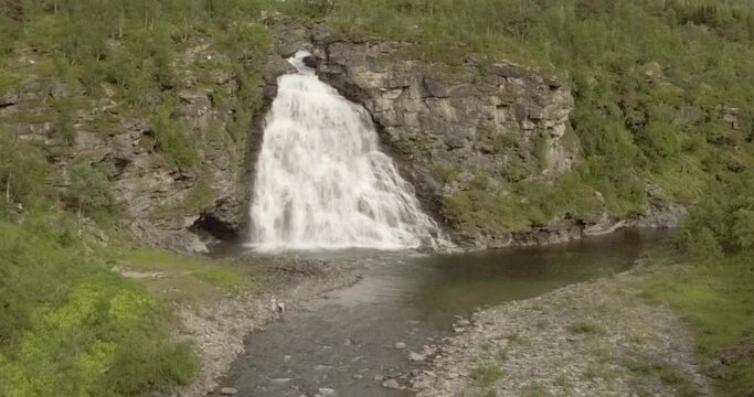 Aerial view of  Rovijokkfossen waterfall on the E8 Nordlysveien road in summer, Storfjord, Troms og Finnmark, Norway.