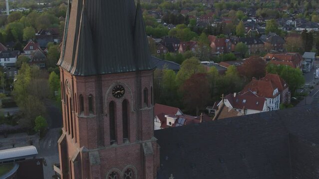 Drone flight around a church in north germany with the sunset
