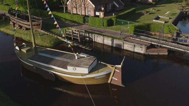 Historical ship in the middle of a canal in the north of Germany in Papenburg Droneshot