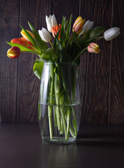 fresh, spring flowers in vase on dark background